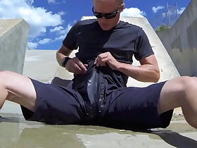 Pissing and cumming inside black shorts in public