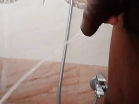 Rajesh pissing in the bathroom